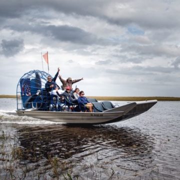 a group of tourists on an airboat tour